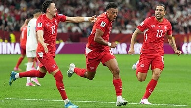 Switzerland football players celebrating after scoring in FIFA World Cup match.