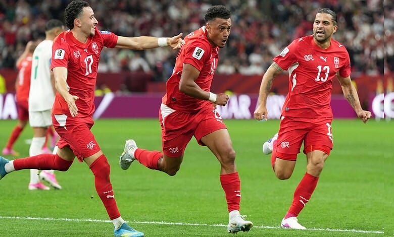 Switzerland football players celebrating after scoring in FIFA World Cup match.