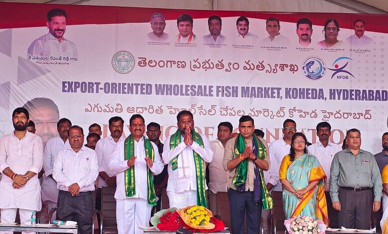 Group of officials and vendors at Hyderabad fish market inauguration event.