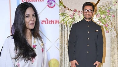 A woman with long dark hair and a man in a black traditional outfit at wedding celebration.