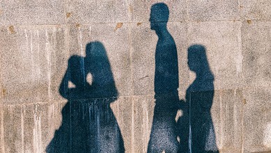 Silhouettes of three girls walking on a wall in Nagpur, India, during daytime.