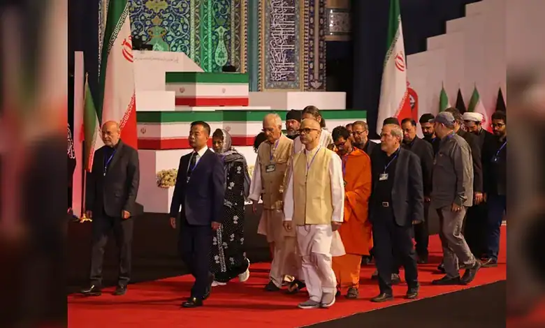 Indian delegation in formal attire pays tribute at a memorial event with Iranian flags in the background.