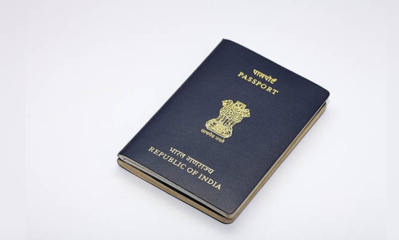 Indian passport booklet with emblem and text on cover, isolated on white background.