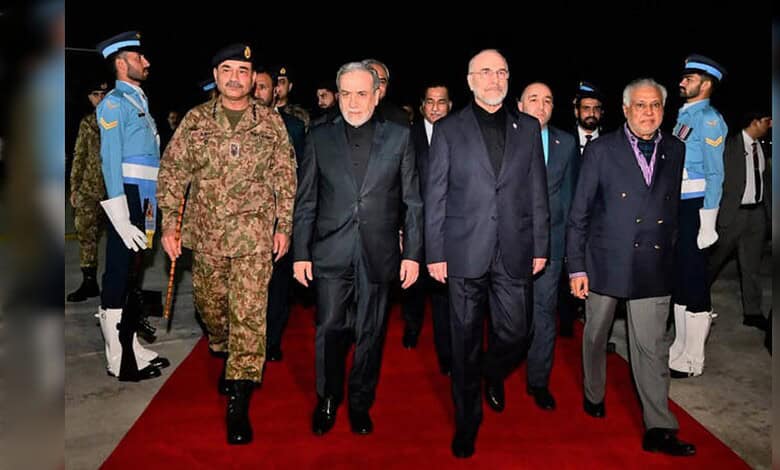 Iran and US officials walking together at a diplomatic event with security personnel in the background.