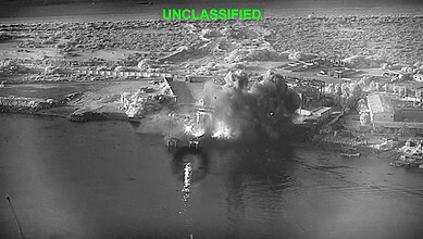 Explosive blast and smoke rising from a bridge during a US airstrike against Iran.