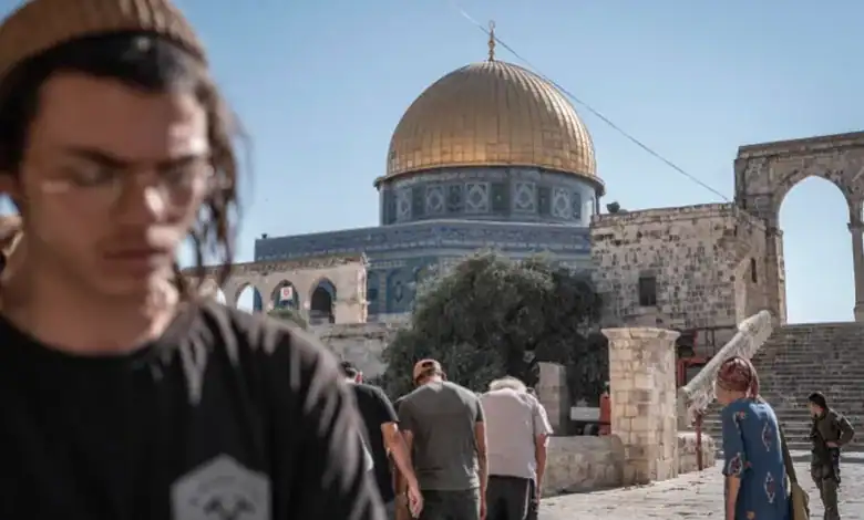 People visiting Al-Aqsa Mosque with the golden dome visible in the background.