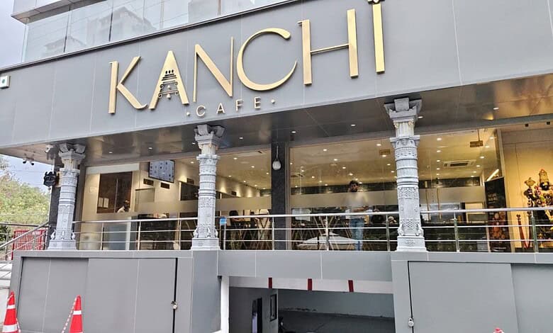 Exterior of Kanchi Cafe with modern design and signage in a busy area.