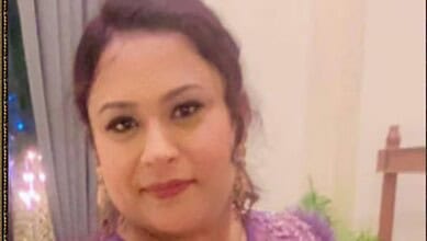Happy Indian woman celebrating her big lottery win at home.