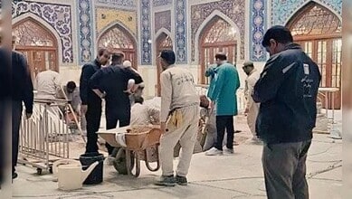 Workers prepare Ayatollah Ali Khamenei's burial site inside the Imam Reza shrine in Mashhad