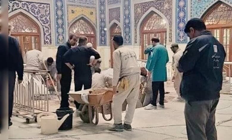 Workers prepare Ayatollah Ali Khamenei's burial site inside the Imam Reza shrine in Mashhad