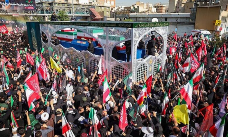 Crowd of mourners with flags participating in Tehran funeral procession for Khamenei.