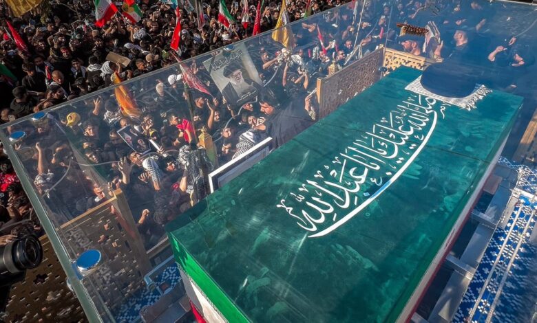 Large crowd gathers for Khamenei's funeral in Najaf, with a glass coffin draped in the Iranian flag.
