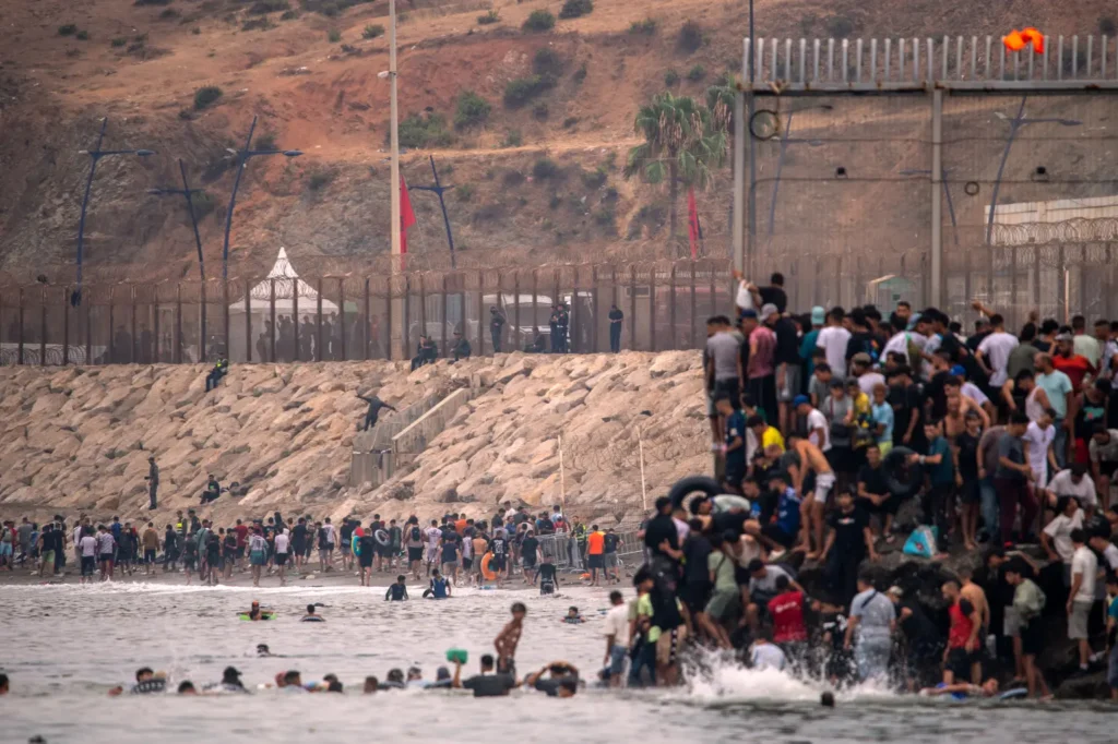 Large crowd of migrants crossing into Spain at Ceuta from Morocco.