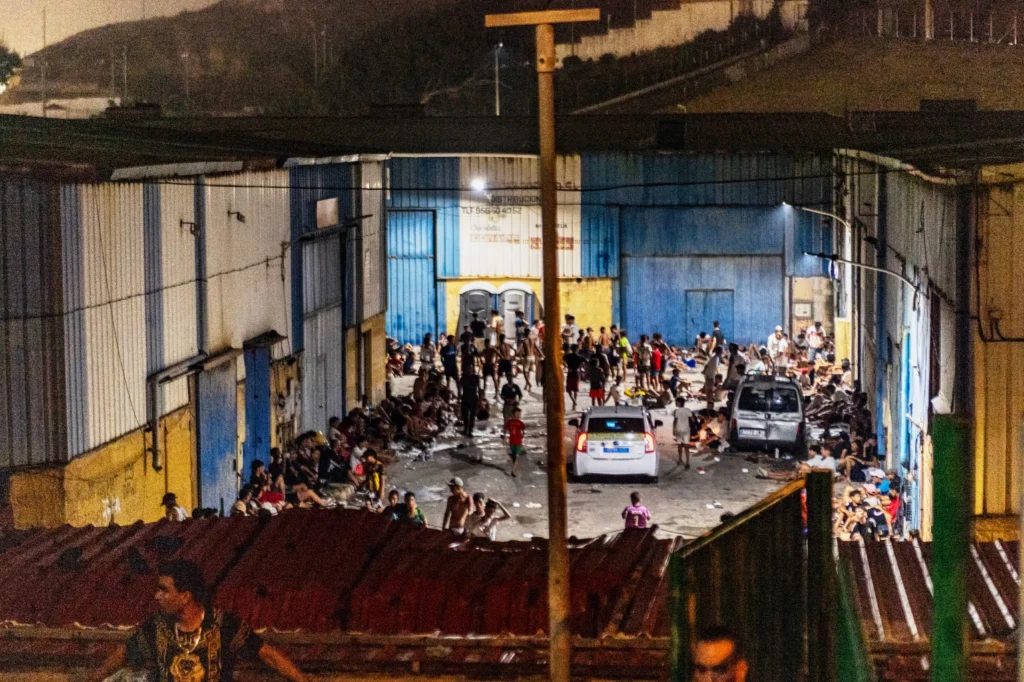 Migrants rest at a temporary holding area in Spain's Ceuta after crossing from Morocco.