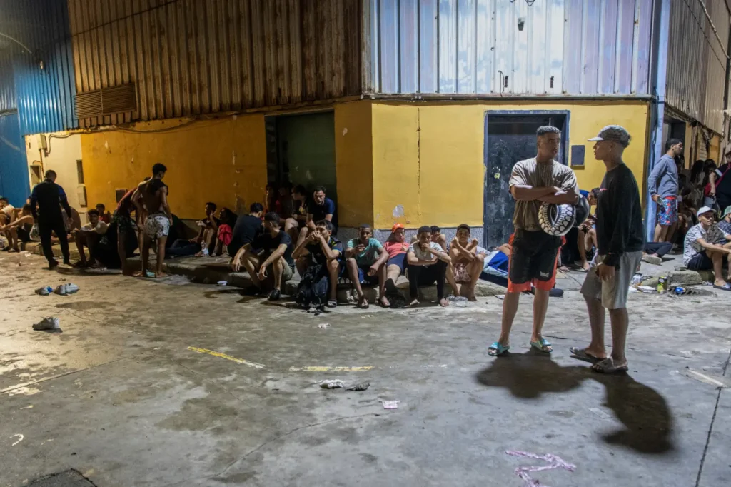 Migrants sit and rest at a temporary shelter in Ceuta.
