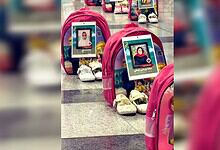 Memorial display with photographs of children at Tehran airport for Minab memorial.