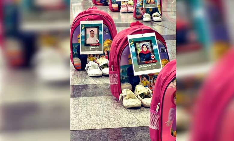 Memorial display with photographs of children at Tehran airport for Minab memorial.
