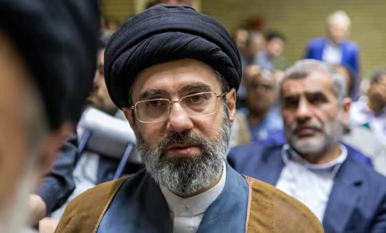 Ali Khamenei with a black turban and glasses at a memorial gathering.