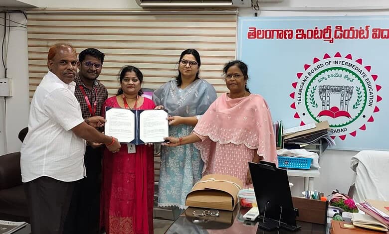 Group of officials and women holding documents at an official event in Hyderabad.