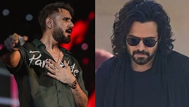 Mustafa Zahid performing on stage with a microphone, wearing a green shirt and a watch.