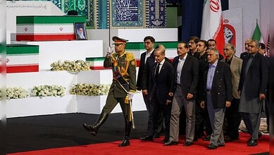 Pakistani officials and military personnel pay tribute during a formal ceremony in Tehran.