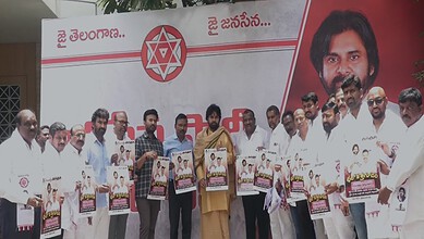 Group of people holding posters at a political event in Telangana, India.