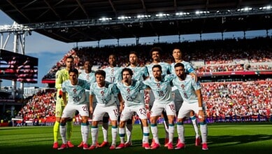 Portugal football team posing before a match at the FIFA World Cup in a packed stadium.