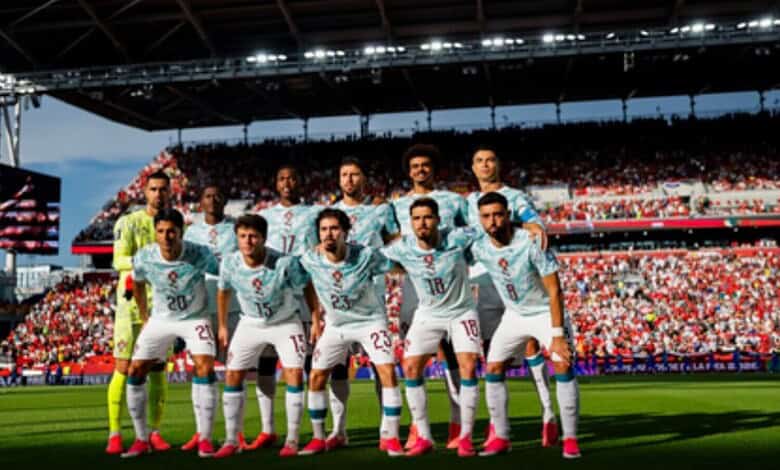 Portugal football team posing before a match at the FIFA World Cup in a packed stadium.