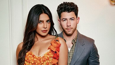 Nick Jonas and Priyanka Chopra posing together at a formal event in stylish attire.