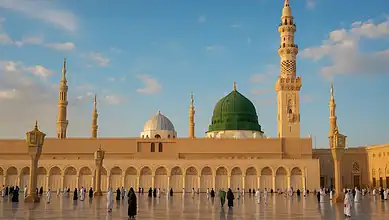 View of the Prophet's Mosque in Madinah with the Green Dome and worshippers in the courtyard.
