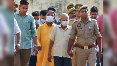 Police personnel escort accused to a court in connection with the alleged embezzlement of Ram Temple donation funds, in Ayodhya, Friday, June 26, 2026. (PTI Photo)