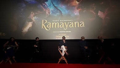 Panel discussion at Ramayana movie event with five speakers on stage.