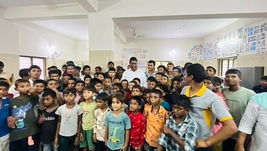 Group of children and teachers in a classroom during an educational event.