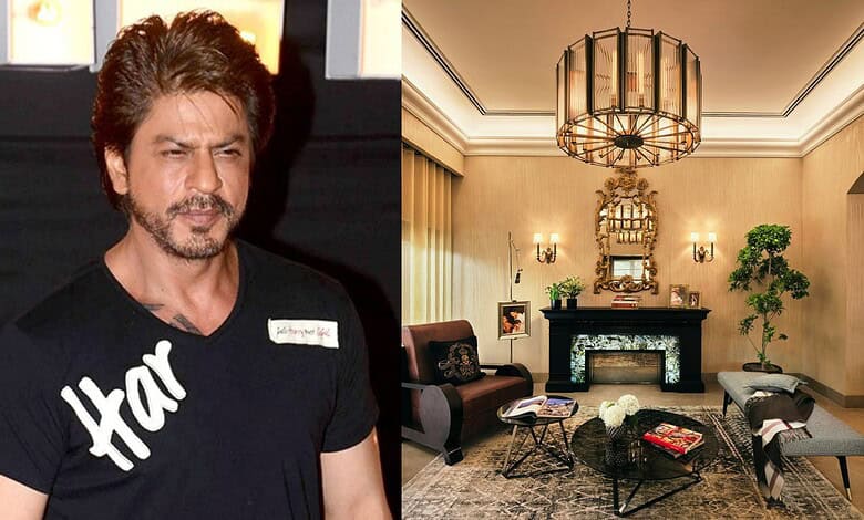 Shah Rukh Khan in a black T-shirt with 'Har' written on it, standing indoors.