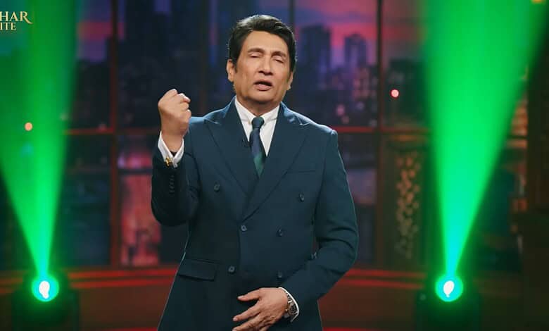 Shekhar Suman hosting his late night show with vibrant green stage lighting.