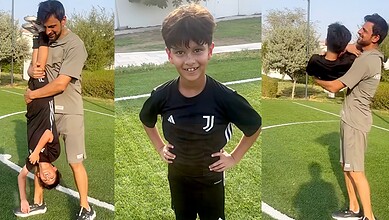 Shoaib Malik with his son Izhaan Mirza Malik in a park setting.