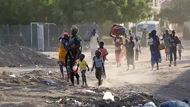Children and families flee their neighbourhoods amid fighting in Khartoum, Sudan.