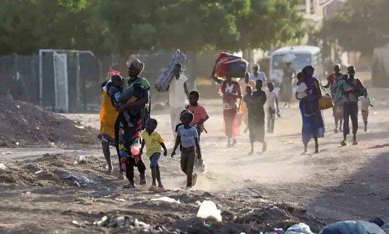 Children and families flee their neighbourhoods amid fighting in Khartoum, Sudan.