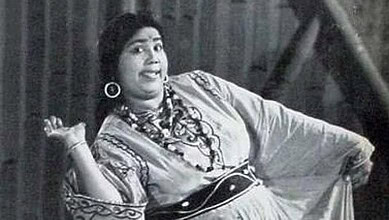 Black and white image of Tun Tun, India's first female comedian, smiling and posing.