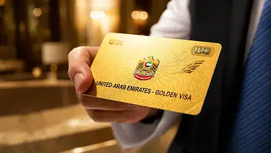 Hand holding a UAE Golden Visa card representing the country's long-term residency programme.