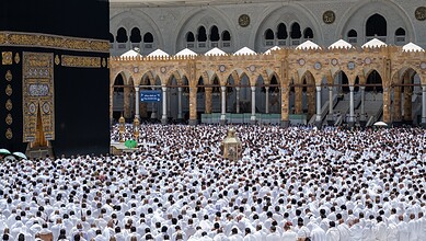 Large crowd of pilgrims performing prayer at Masjid al-Haram in Mecca, Saudi Arabia.