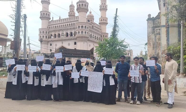 Students protesting in Hyderabad after exam results, holding placards demanding justice.