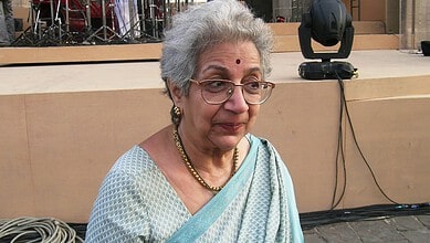 Veteran theatre director Vijaya Mehta at a public event, wearing glasses and traditional attire.