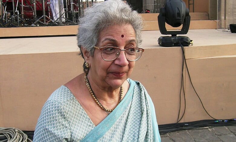 Veteran theatre director Vijaya Mehta at a public event, wearing glasses and traditional attire.