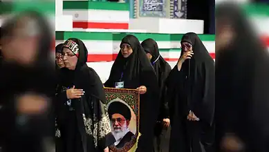 Women mourners hold a portrait of Ayatollah Ali Khamenei during a tribute ceremony at Tehran's Grand Mosalla.