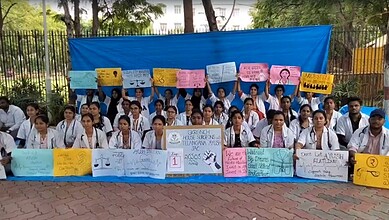 Group of Telangana AYUSH doctors protesting with banners and placards during strike.