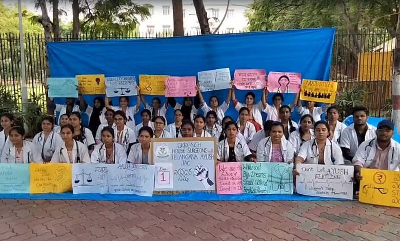 Group of Telangana AYUSH doctors protesting with banners and placards during strike.