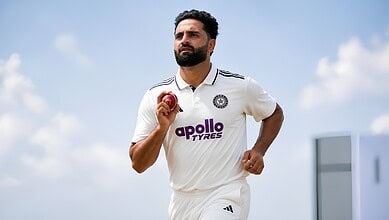 J-K fast bowler Auqib Nabi holding a cricket ball on the field.