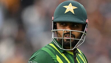 Pakistani cricketer Babar Azam in cricket gear during a match.