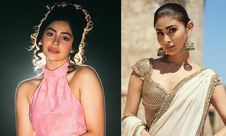 Two women in traditional Indian attire, one in pink and the other in cream with gold embellishments.